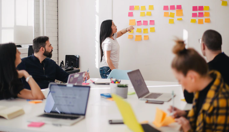 Small team reviewing figures around a table