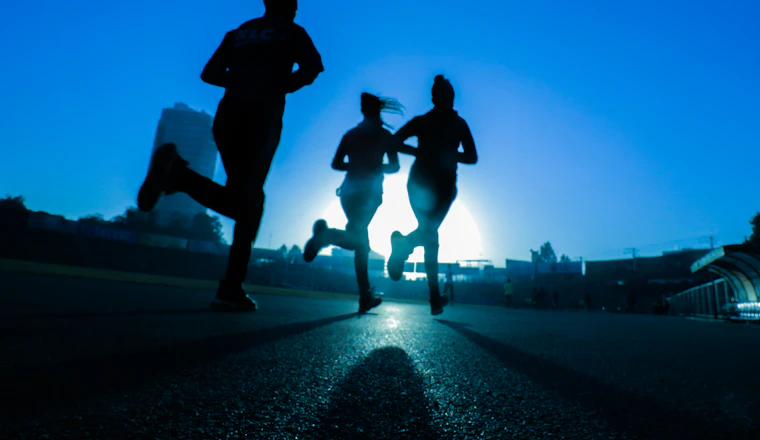 Runner using a sports watch on a track